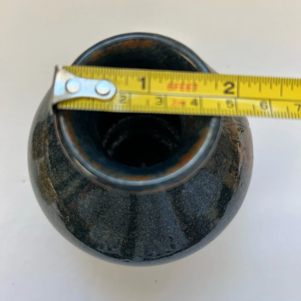 Handmade art pottery vase with a glossy glaze blend of blue and brown/ signed